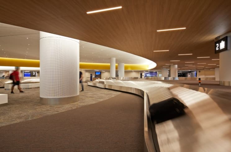A baggage carousel at SFO, with a suitcase riding the belt.